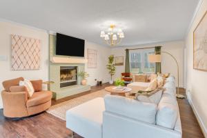 a living room with a couch and a fireplace at 5 Bdrm Family Retreat, Pool, HotTub, Golf, Firepit in Greensboro