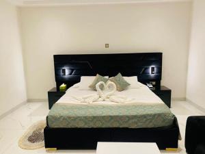 a bedroom with a large bed with a bow on it at Viva Hôtel Ouaga 2000 in Ouagadougou