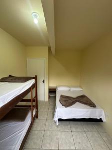 Ένα ή περισσότερα κρεβάτια σε δωμάτιο στο Vila das Dunas - Santinho