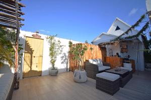 a patio with a couch and a table and a fence at Casa Nomis Cancun in Cancún