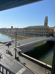 a bridge over a body of water in a city at Lungarno Suite in Pisa
