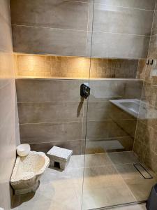 a bathroom with a shower with a toilet and a sink at Bayt Nour - Alger Riyadh City Oued El Moussa in Ouled Moussa