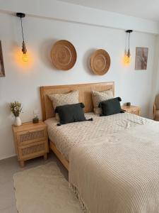 a bedroom with two beds and two night stands at Bayt Nour - Alger Riyadh City Oued El Moussa in Ouled Moussa