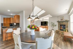 a kitchen and dining room with a table with flowers at Private Yard and Pond Views Fort Wayne Family Home! in Arcola