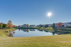 a river in a field with the sun in the sky at Private Yard and Pond Views Fort Wayne Family Home! in Arcola