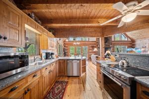 a large kitchen with wooden cabinets and a ceiling at Mountain Masterpeace in Banner Elk