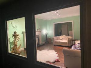 a living room with a couch and a mirror at Suite in Lakeside house in Alpharetta