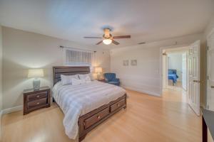 a bedroom with a bed and a ceiling fan at Villa with Pool Home and Outdoor space! in Cape Coral +29 photos
