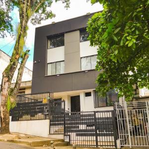 a house with a black fence in front of it at Mi Fortaleza Cali, Valle del Cauca Santa Isabel Cerca a IMBANACO in Cali