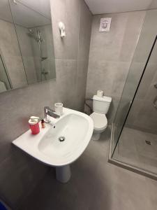 a bathroom with a white sink and a toilet at BLUE Cabin-Larnaca Centrum in Larnaka