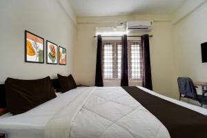 a large white bed in a room with a window at Collection O Govt Engineering College Formerly Anby Plaza in Trivandrum
