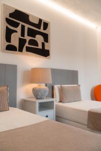a bedroom with two beds and a table with a lamp at Canaryislandshost I Viñedos in Uga