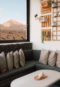 a living room with a couch and a table at Canaryislandshost I Viñedos in Uga