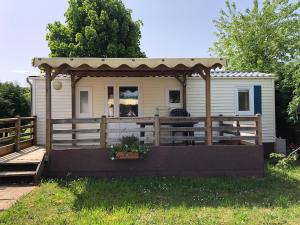 a tiny house with a gazebo at CAMPING de la BUGE in Rochefort-Montagne