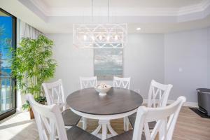 a dining room with a table and white chairs at Phoenix on the Bay 1134 condo in Caswell