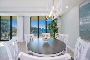 a dining room with a table and white chairs at Phoenix on the Bay 1134 condo in Caswell