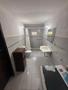 a bathroom with a toilet and a sink at CASA Barrio Parque Mar in Miramar