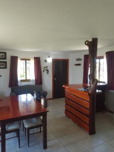 a living room with a wooden table and a couch at CASA Barrio Parque Mar in Miramar +6 photos
