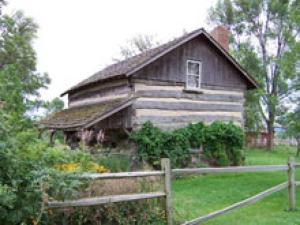 a wooden house with a fence in front of it at Augustus Chetlain Home & Log Cabins in Galena
