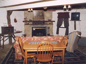 a dining room with a table and a fireplace at Augustus Chetlain Home & Log Cabins in Galena