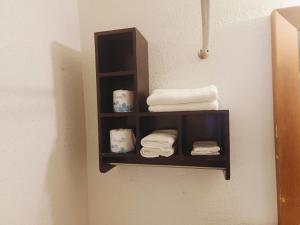 a shelf in a bathroom with towels on it at Sunset Inn by Hotel O Flatonia I - 10 in Flatonia +35 photos