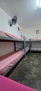 a room with two bunk beds and a light at Hospedagem Santa Gertrudes Comensoli in Cachoeira Paulista +13 photos