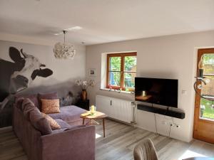 a living room with a couch and a cow on the wall at Allgäunest in Oberstdorf
