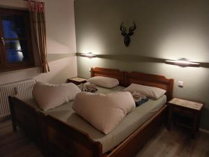 a bedroom with a bed with two pillows on it at Allgäunest in Oberstdorf