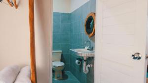 une salle de bain avec toilettes et lavabo dans l'établissement Casa Hijos del Cocho Bacalar, à Bacalar