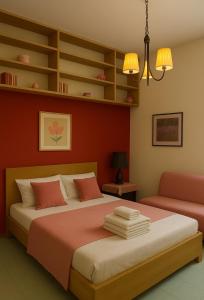 a bedroom with a bed and a couch at REALE COLOSSEO TREVI HOME - private garden in Rome +13 photos