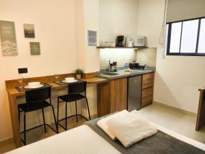 a small kitchen with two bar stools in a room at Mi Fortaleza Cali, Valle del Cauca Santa Isabel Cerca a IMBANACO in Cali +52 photos
