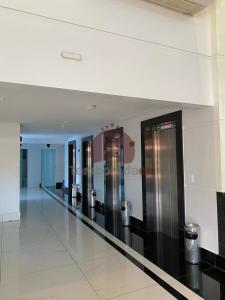 a hallway with stainless steel elevators in a building at Piazza com Acesso ao Acqua Park - Temporada CN in Caldas Novas +36 photos