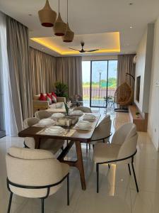 a dining table and chairs in a living room at The Mangrove at Carey Circles 