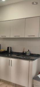 a kitchen with white cabinets and a counter top at Al paso Maschwitz in Ingeniero Maschwitz