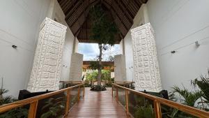 a hallway of a church with a wooden walkway at Hotel Mundo Maya Palenque in Palenque