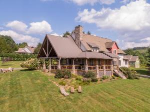 a large house on top of a grass field at Robin Hoods Retreat in Jefferson