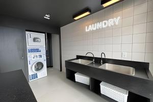 a laundry room with a sink and a washing machine at Art. in Santa Maria +112 photos
