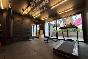 a fitness room with a treadmill and a gym at Art. in Santa Maria