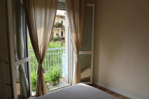 a bedroom with a window with a view of a balcony at Delicious next to Florence in Scandicci