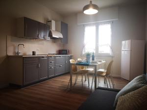 a kitchen with a table and a white refrigerator at Delicious next to Florence in Scandicci