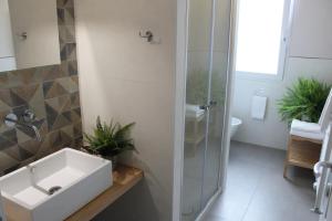 a bathroom with a sink and a glass shower at Delicious next to Florence in Scandicci