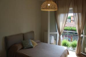 a bedroom with a bed and a large window at Delicious next to Florence in Scandicci