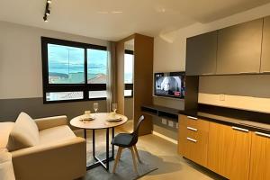 a small living room with a table and a chair at Art. in Santa Maria