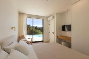 a bedroom with a bed and a view of a pool at Casa das Costinhas in Loureda