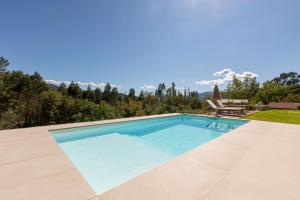 a swimming pool in a villa with a view at Casa das Costinhas in Loureda