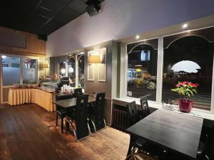 a dining room with tables and chairs and a window at CoronaZeist-Utrecht NL in Zeist