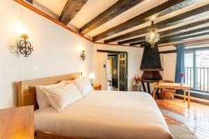 a bedroom with a large bed and a table at Villa Coyoacán Colonial in Mexico City
