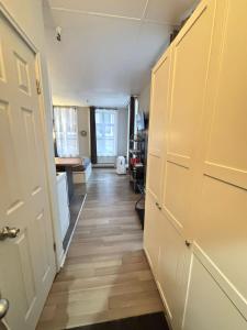 a hallway of a room with a door and wooden floors at Urban Loft, St-Joseph St in Quebec City