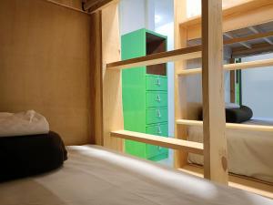 a small bedroom with bunk beds and a window at Jardin 85 Hostel in Morelia +63 photos