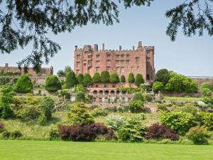an old castle on a hill with a garden at 9 Bed in Welshpool 40870 in Llanfyllin